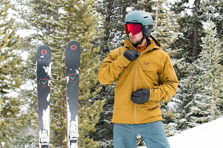 Arc'teryx Macai ski jacket (zipping up with skis)